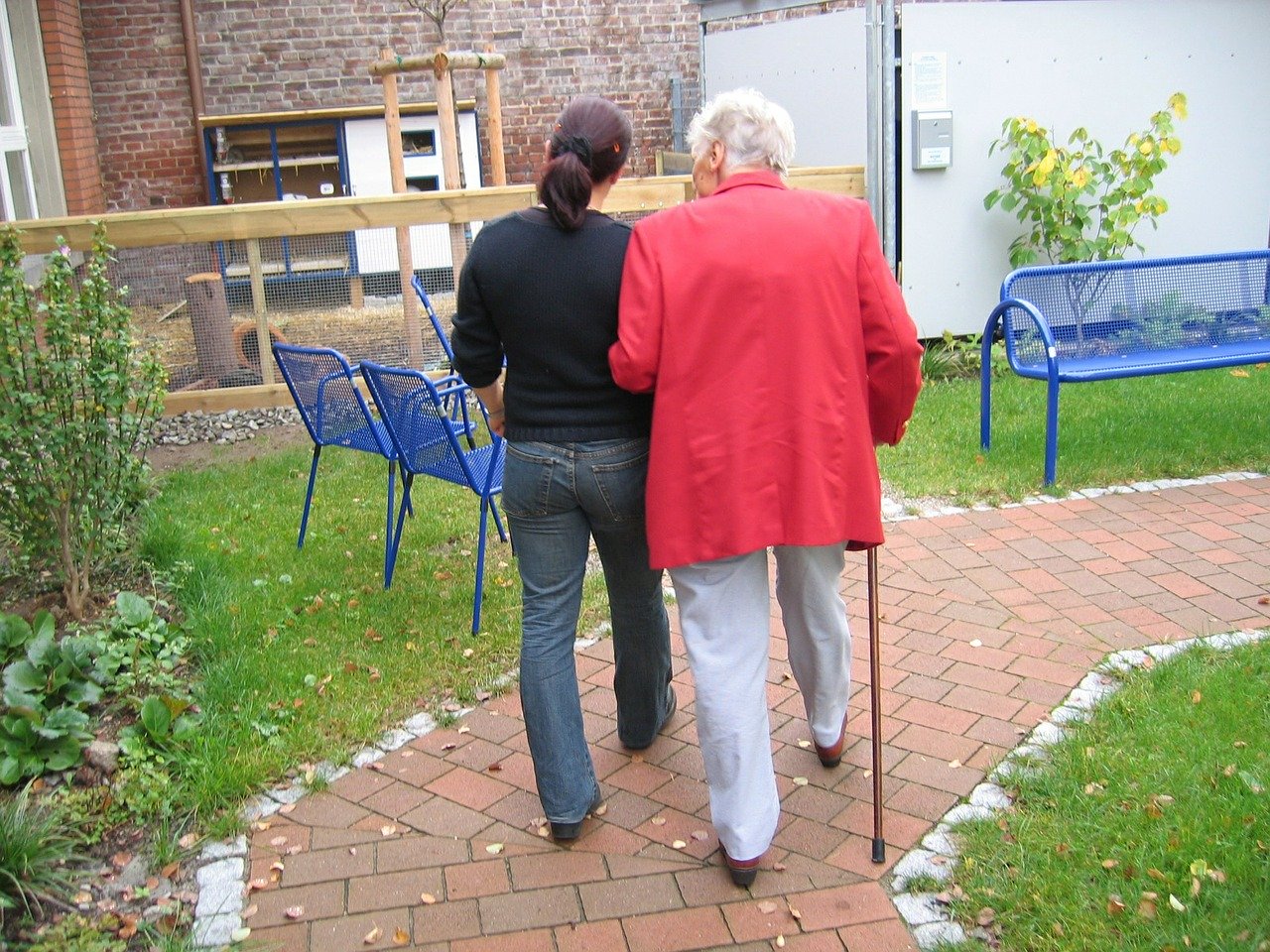 résident de maison de retraite en promenade avec un soignant